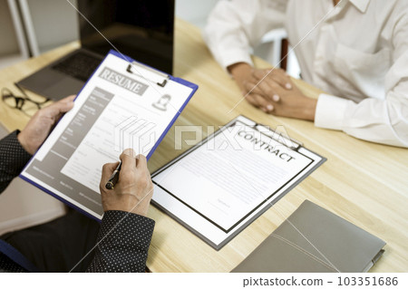 businessman considering resume application with an employment businessman considering resume application with an employment 103351686