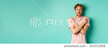 Nervous guy with red hair staring indecisive, cross arms and pointing sideways, showing two variants with puzzled face, standing in t-shirt over mint background 103352808
