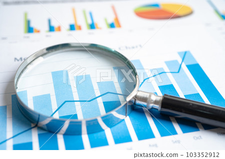 Magnifying glass on graph paper. Financial development, Banking Account, Statistics, Investment Analytic research data economy, Business concept. 103352912