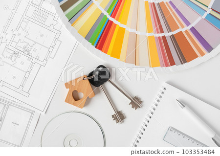 Hands choosing Colors of Interior Design from the Color Guide. Apartment Sketch, Paint palette, Model of House and Keyring on the Background. Architect Using Color Swatch. House Plan with Blueprints Hands choosing Colors of Interior Design from the Color Guide. Apartment Sketch, Paint palette, Model of House and Keyring on the Background. Architect Using Color Swatch. House Plan with Blueprints 103353484