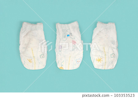 Baby diapers collection on blue color background. Newborn flat lay, top view. Pastel color. Baby care concept. Accessories for children's hygiene 103353523