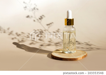Natural oil cosmetics on wooden pedestal. Blank Dropper glass Bottle Mock-Up. Oily cosmetic pipette. Spa concept. Mineral organic oil. beauty products 103353548