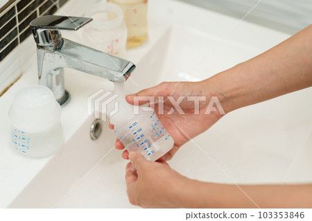mother hand washing baby plastic milk bottle mother hand washing baby plastic milk bottle 103353846
