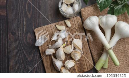 Image of peeling garlic Image of peeling garlic 103354825