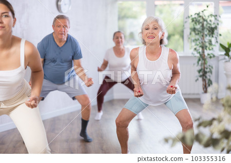 Mature woman with visitor actively moves and learns to dance hip hop Mature woman with visitor actively moves and learns to dance hip hop 103355316