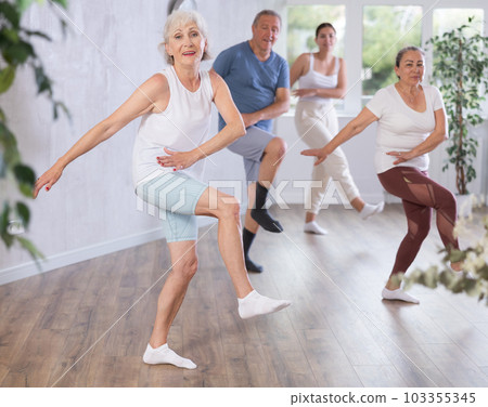 Mature woman with visitor actively moves and learns to dance hip hop Mature woman with visitor actively moves and learns to dance hip hop 103355345
