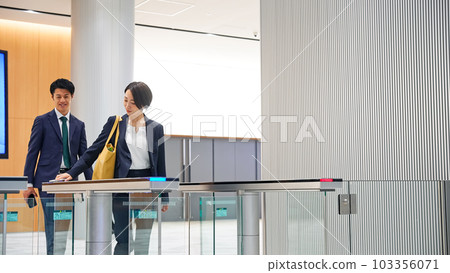 Business person passing through the entrance gate 103356071