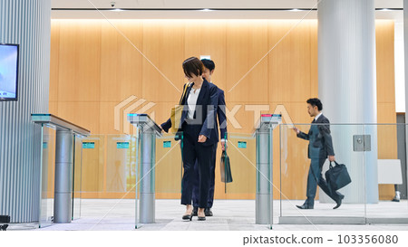 Business person passing through the entrance gate 103356080