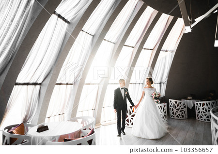 Wedding couple holding hands, groom and bride together on wedding day 103356657