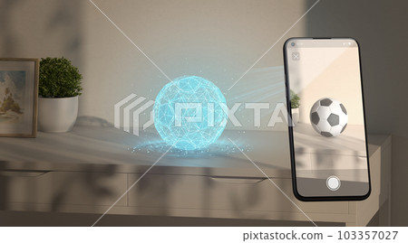 Virtual soccer ball hologram on table phone display augmented reality Virtual soccer ball hologram on table phone display augmented reality 103357027