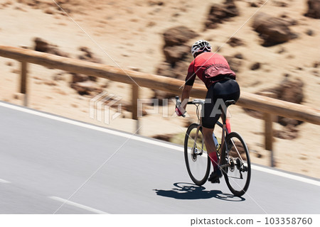 Road bike cyclist man cycling. Athlete on a race cycle. Biking sport fitness athlete biking on road bike. Panning technique used Road bike cyclist man cycling. Athlete on a race cycle. Biking sport fitness athlete biking on road bike. Panning technique used 103358760