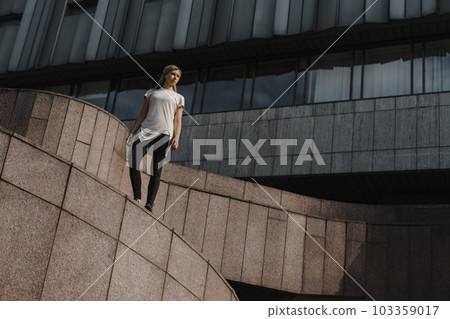 Portrait of young sporty parkour woman. Freeruning female Portrait of young sporty parkour woman. Freeruning female 103359017