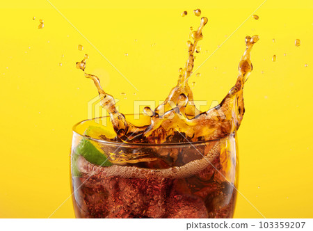 coke glass full of liquid and ice with splash. 103359207