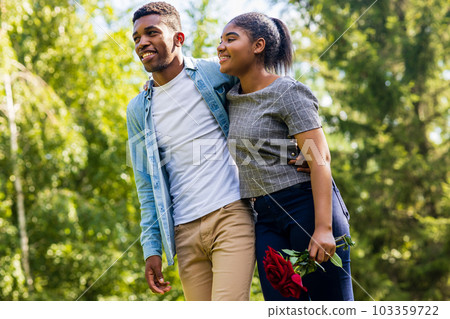 Smiling african couple at romantic picnic in summer park dation at sunny day Smiling african couple at romantic picnic in summer park dation at sunny day 103359722