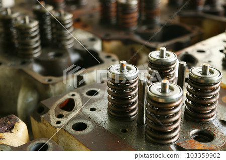 model of a vehicle engine, engine exhaust valve and intake valve, spring valve of the engine and auto spare parts, machine parts damaged from work. 103359902