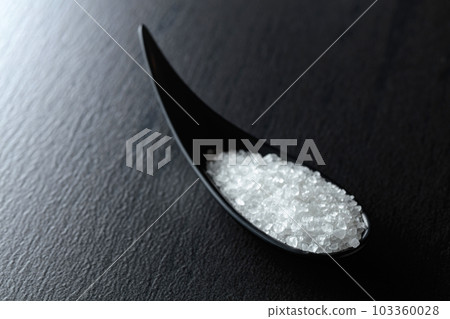Sea salt on a black ceramic table. 103360028