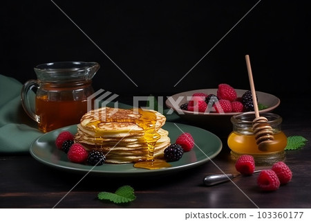 pancake spread with honey and raspberry on a plate on a dark background 103360177