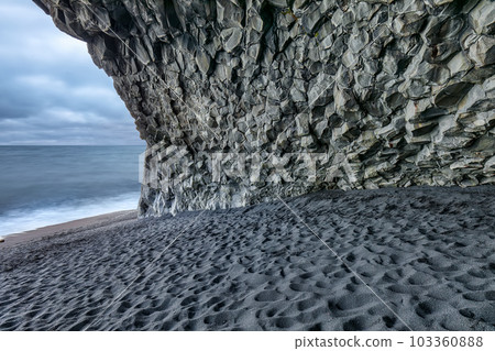 Breathtaling landscape with basalt rock formations on Black beach Reynisfjara near the village of Vik Breathtaling landscape with basalt rock formations on Black beach Reynisfjara near the village of Vik 103360888