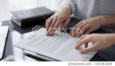 Business people discussing contract signing deal while sitting at the glass table in office, closeup. Partners or lawyers working together at meeting. Teamwork, partnership, success concept 103361800
