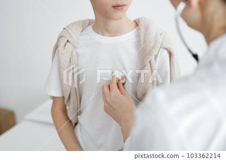 Doctor is examining a kid patient with a stethoscope. Perfect health concept in medicine Doctor is examining a kid patient with a stethoscope. Perfect health concept in medicine 103362214