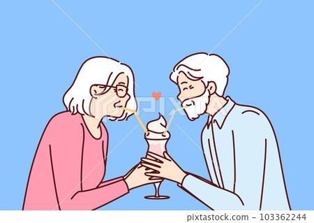 Elderly romantic couple drinking cocktail from straws together enjoying retirement and dating 103362244