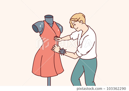 Man fashion designer sews dress fixed on mannequin preparing women outfit for haute couture week 103362290