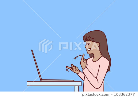 Silent teenage girl using laptop and sign language making video call to friends or school teacher 103362377