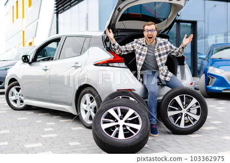 Car mechanic working in car showroom and changing wheel alloy tire. Repair or maintenance auto service. Car mechanic working in car showroom and changing wheel alloy tire. Repair or maintenance auto service. 103362975