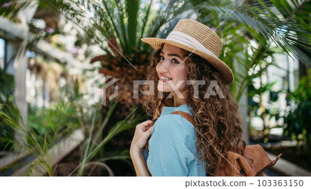 Portrait of young woman in botanical garden. Portrait of young woman in botanical garden. 103363150