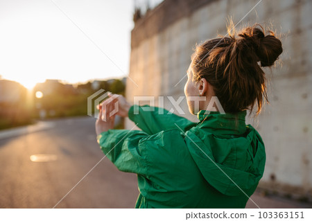 Young woman in sportive clothes doing stretching. Young woman in sportive clothes doing stretching. 103363151