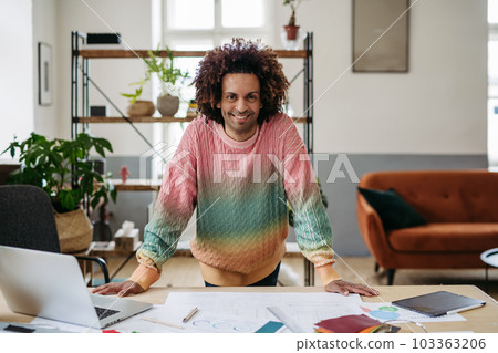 Portrait of young multiracial man in office. 103363206