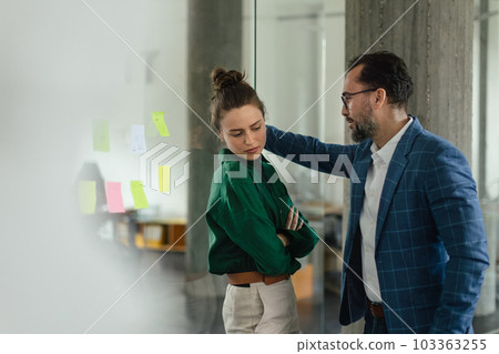 Mature man abusing his younger colleague, concept of harassment at workplace. Mature man abusing his younger colleague, concept of harassment at workplace. 103363255