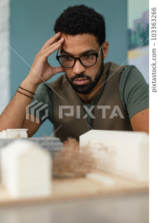 Young architect hard working on design of new house, building. 103363266