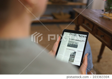 Detail of tablet with news article on screen. 103363304