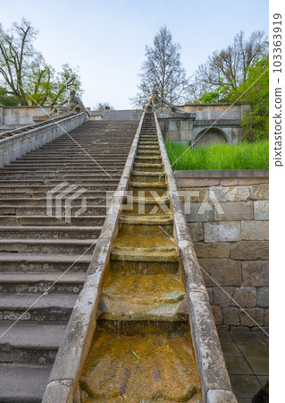 Historical baroque staircase with water cascades on each side and Triton sculptures on the top. Kuks, Czech Republic 103363919