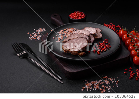 Delicious beef steak with salt, spices and herbs on a ceramic plate Delicious beef steak with salt, spices and herbs on a ceramic plate 103364522