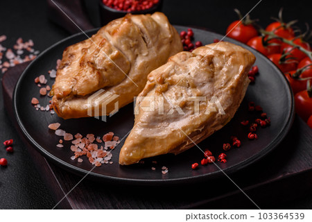 Delicious fresh grilled chicken fillet with salt, spices and herbs on a ceramic plate 103364539