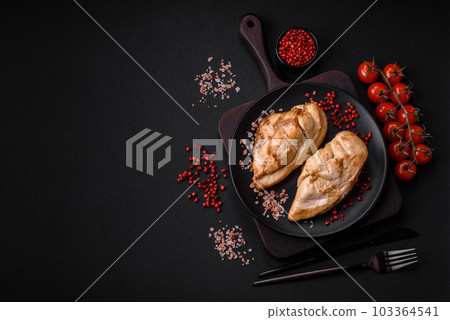 Delicious fresh grilled chicken fillet with salt, spices and herbs on a ceramic plate 103364541