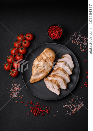 Delicious fresh grilled chicken fillet with salt, spices and herbs on a ceramic plate 103364557