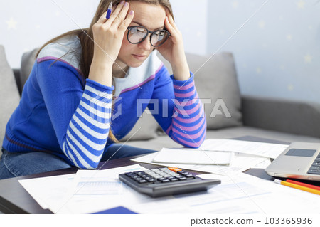 Woman manage household finances frustrated with family financial problems 103365936