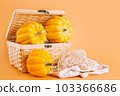 Autumn vegetables.Halloween Pumpkins.Various of pumpkins in a mesh bag of fabric Orange background.Copy space.Vegetable fall food concept.Composition of different varieties pumpkins.Happy Thanksgiving 103366686