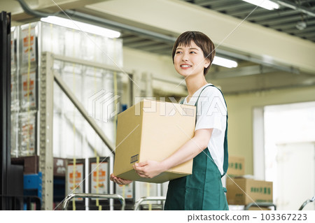Young woman working in a warehouse Young woman working in a warehouse 103367223