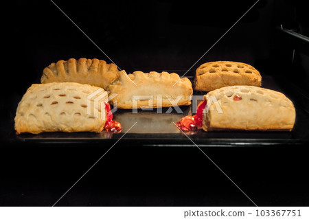 Five baked homemade buns with fruit jam in electric oven 103367751