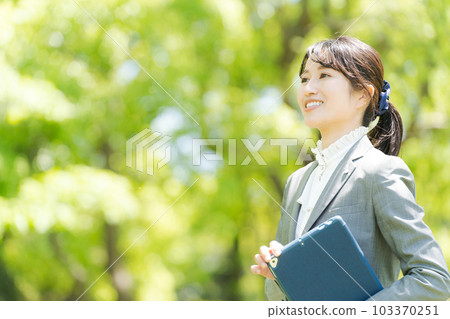 Photo of a woman standing in the greenery 103370251