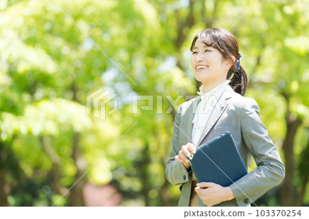 Photo of a woman standing in the greenery Photo of a woman standing in the greenery 103370254