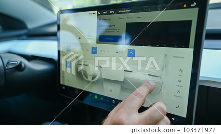 Caucasian man drives a modern electric car on a digital screen.  103371972