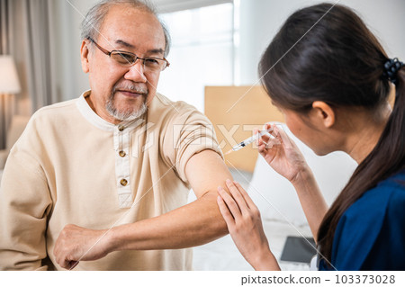 Doctor giving injection with syringe to retired senior man at clinic or hospital, Asian elderly old man getting coronavirus vaccine with nurse, syringe injection on shoulder, medical and healthcare 103373028