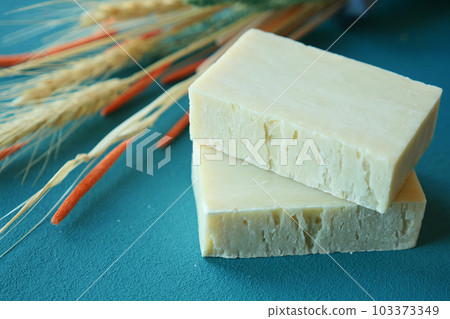 Homemade natural soap bar and dry flower on black background Homemade natural soap bar and dry flower on black background 103373349