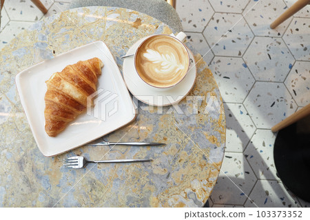 a cup of late coffee with flower shape design on top at cafe a cup of late coffee with flower shape design on top at cafe 103373352