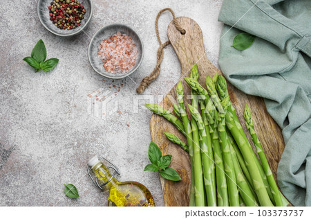 Bunch of raw asparagus stems with different spices Bunch of raw asparagus stems with different spices 103373737